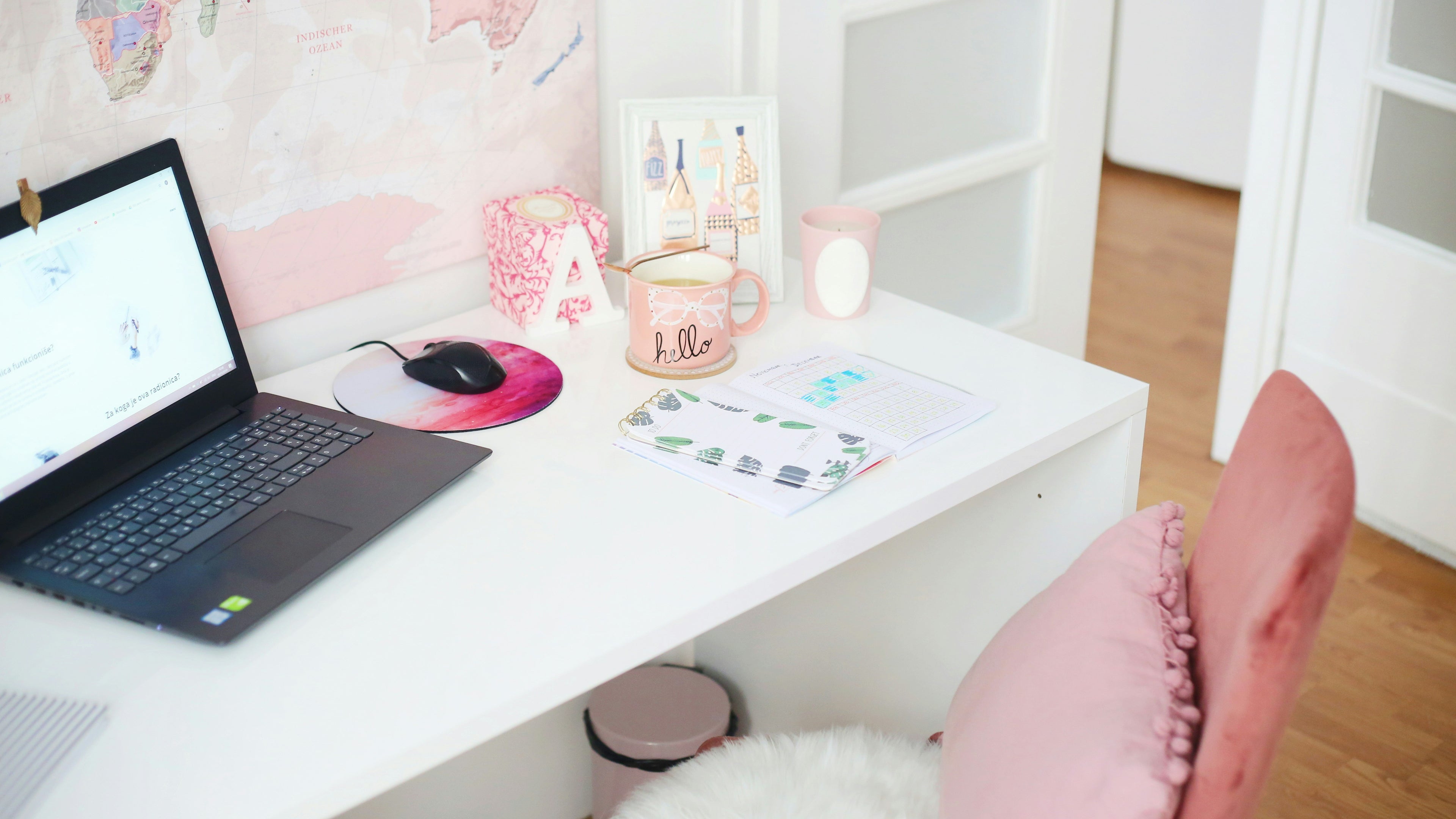 Bright White Desk with Laptop and Pink Chair and Room Accents 